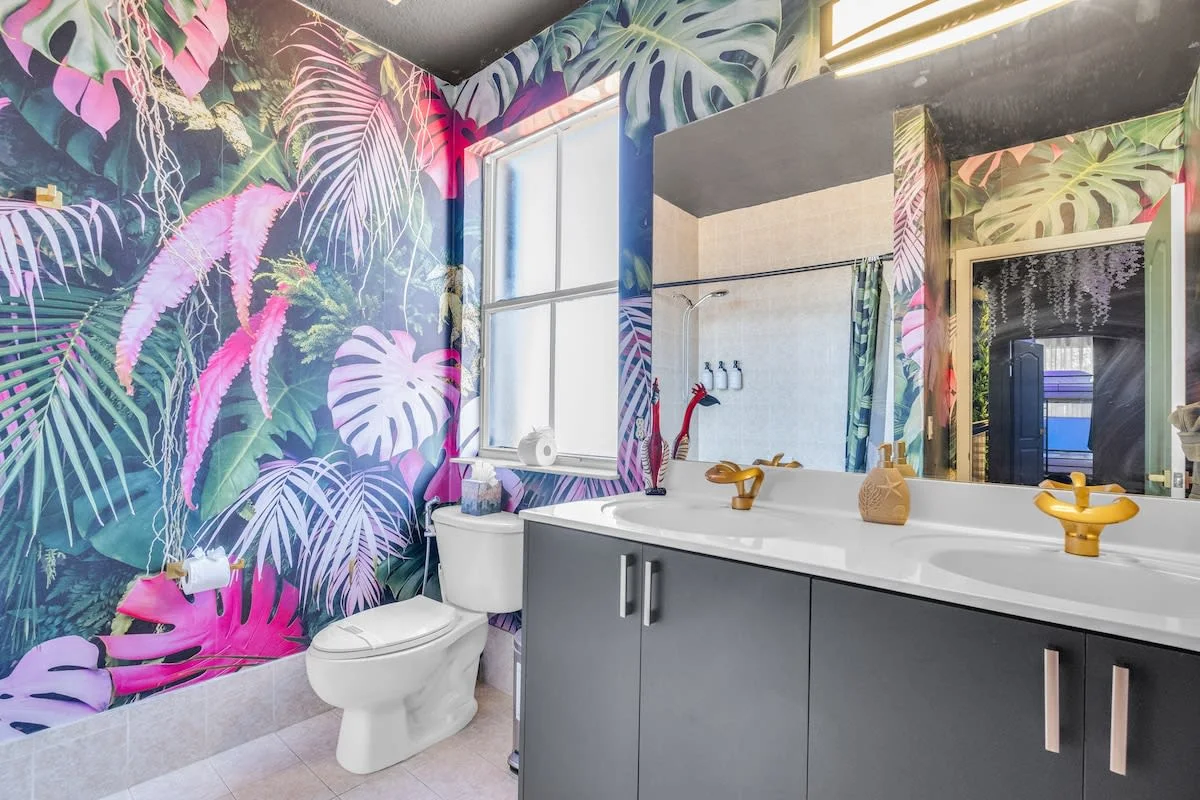 Baño con mural tropical